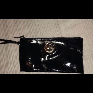 Barely used Michael Kors black and gold wristlet